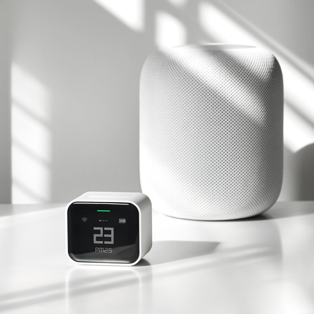 White smart home device on a reflective surface with a light background